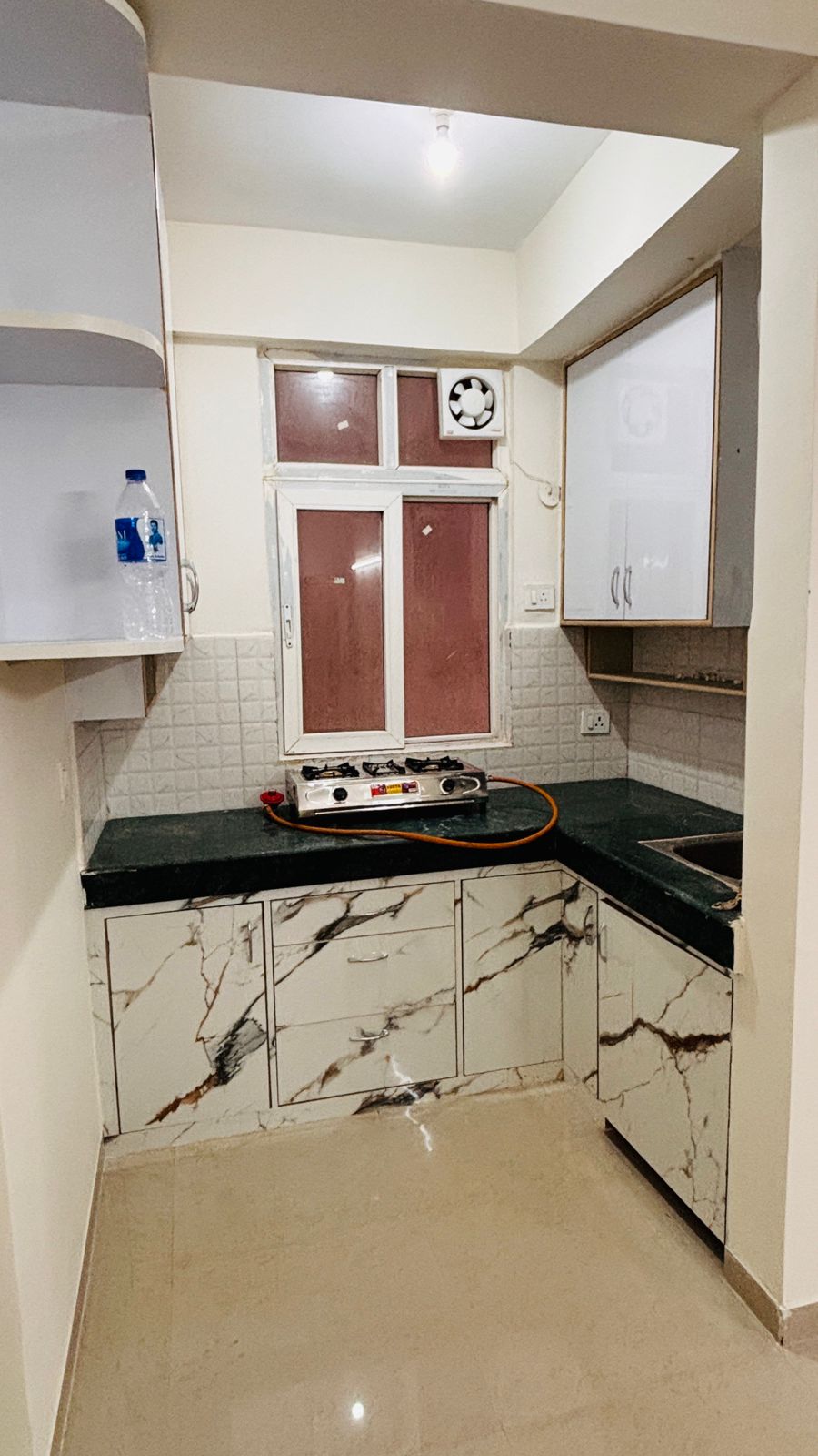 Modern kitchen with marble countertops.