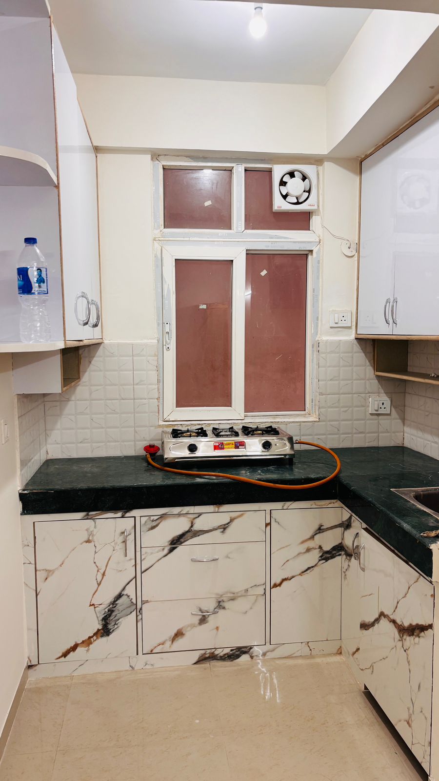 Modern kitchen with marble countertops.